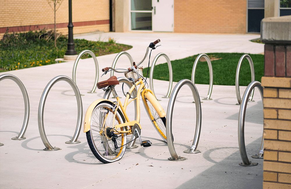 Parallel bike rack installed at a university campus with multiple bicycles parked in organized rows for efficient high-traffic use